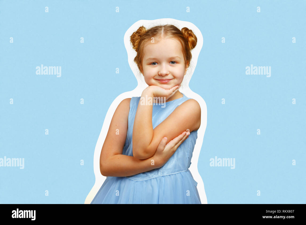 Portrait of a cute little child girl in a blue dress on a colored background. Stock Photo