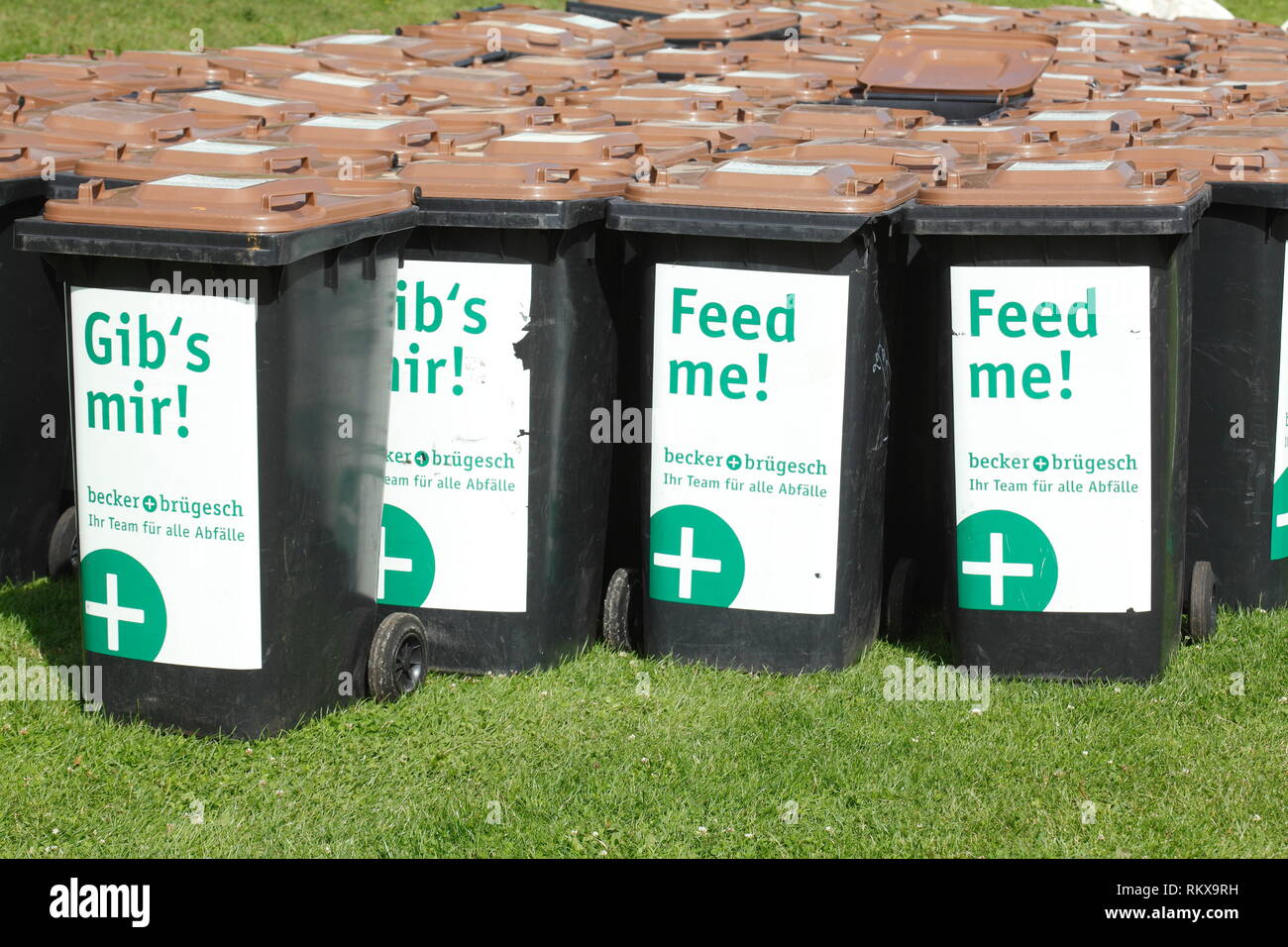 Brown garbage bins standing on a meadow, Germany, Europe Stock Photo