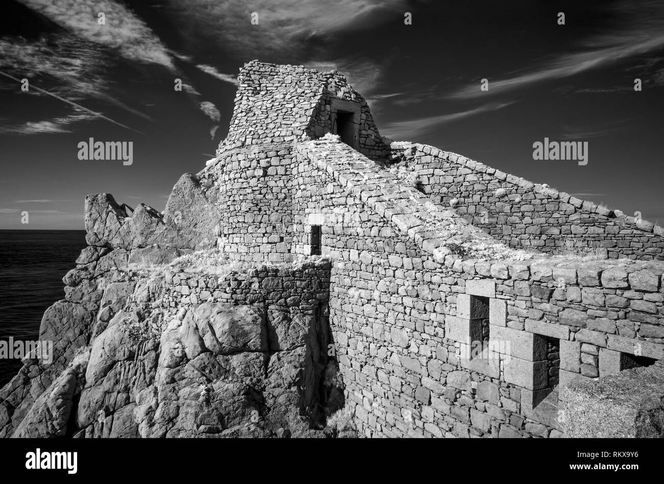 An infrared image of Fort Chateau a' L'Etoc on Alderney, Channel Islands. Stonework texture is enhanced in infrared. Stock Photo