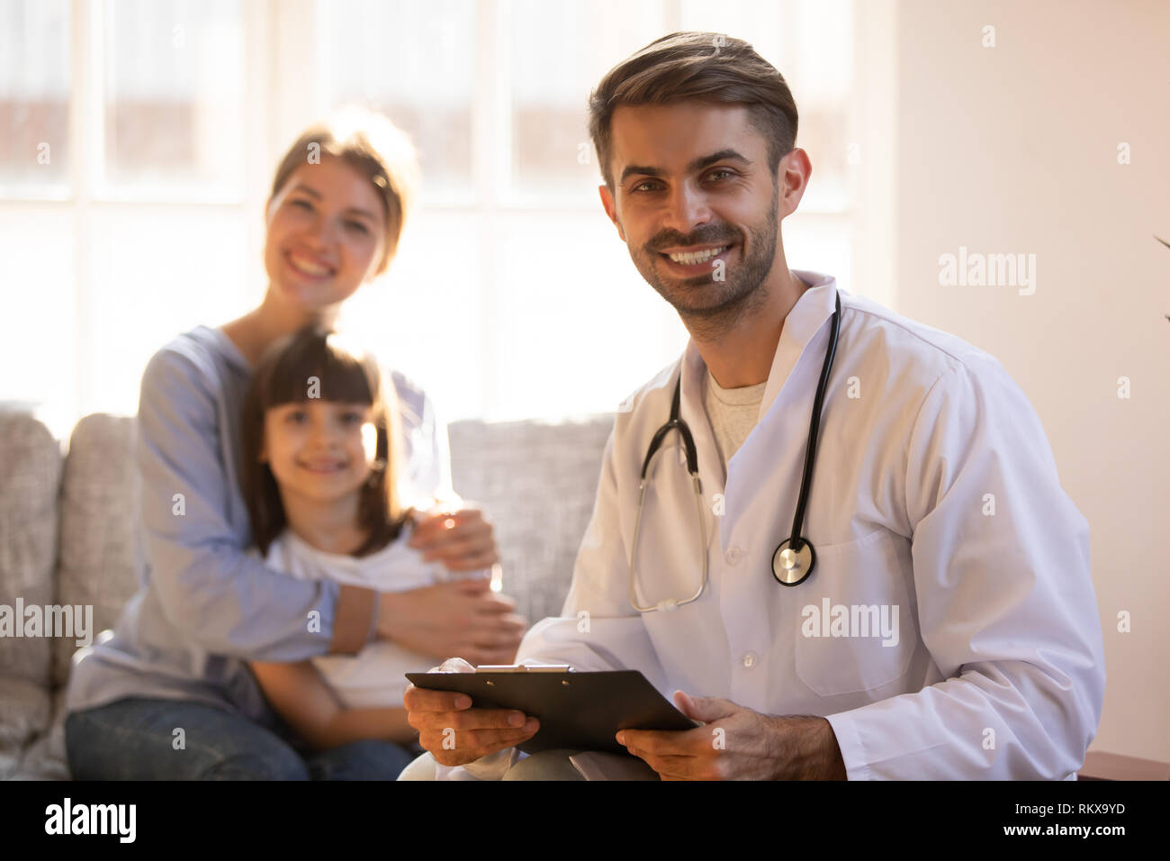 Male professional doctor pediatrician holding clipboard looking in camera Stock Photo