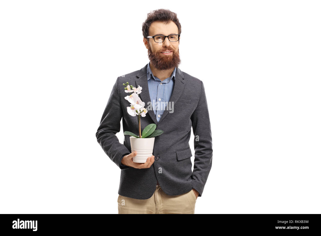 Smiling young man with a beard holding a mini white orchid isolated on white background Stock Photo