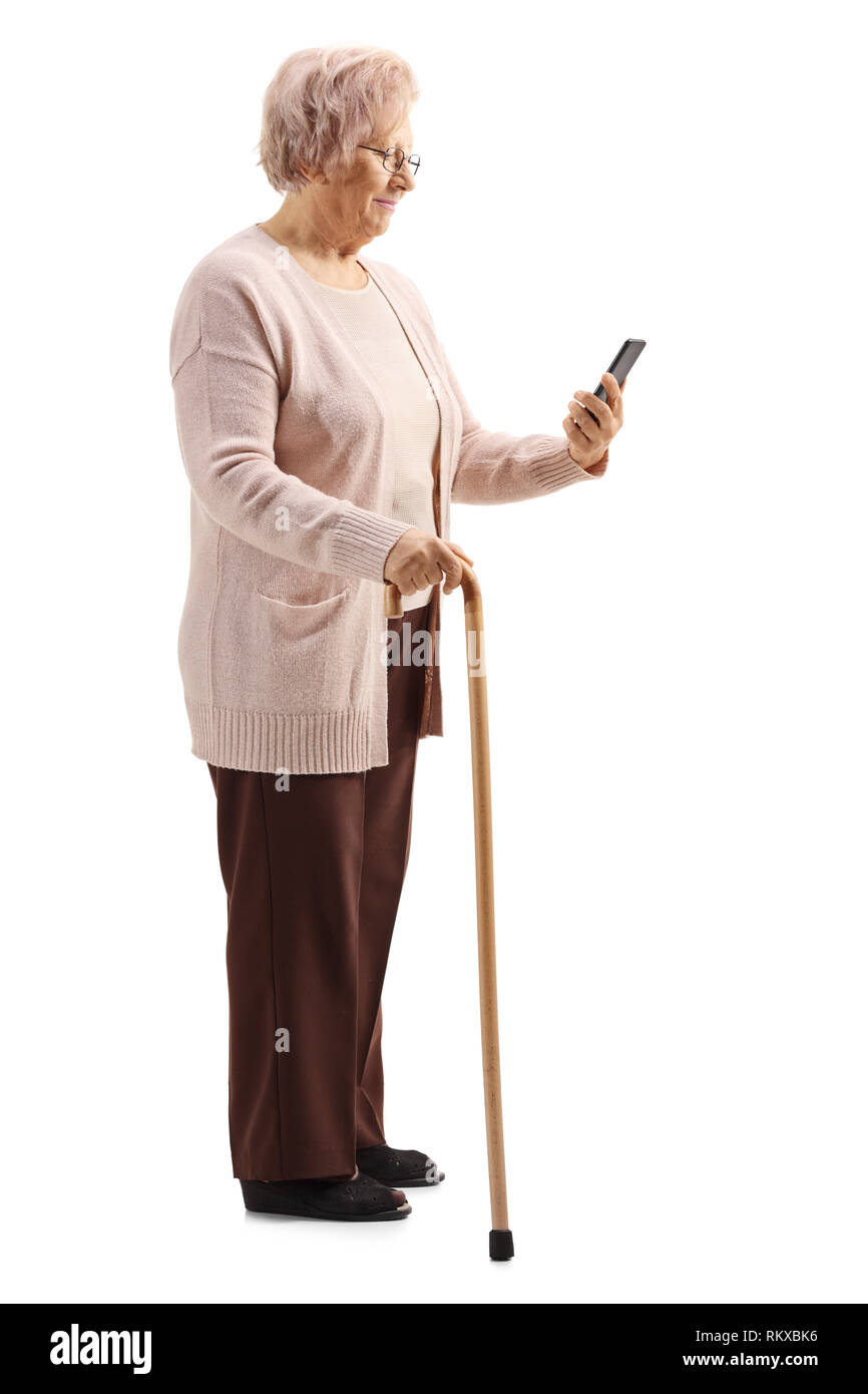 Full length shot of a senior woman with a cane looking at a mobile phone isolated on white background Stock Photo