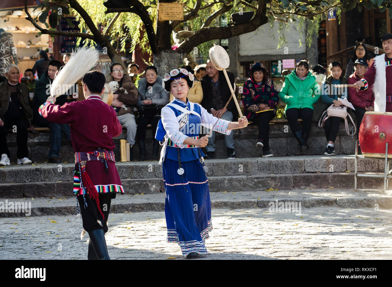 Naxi man and woman performing a traditional cultural dance, Lijiang old town, Yunnan, China Stock Photo