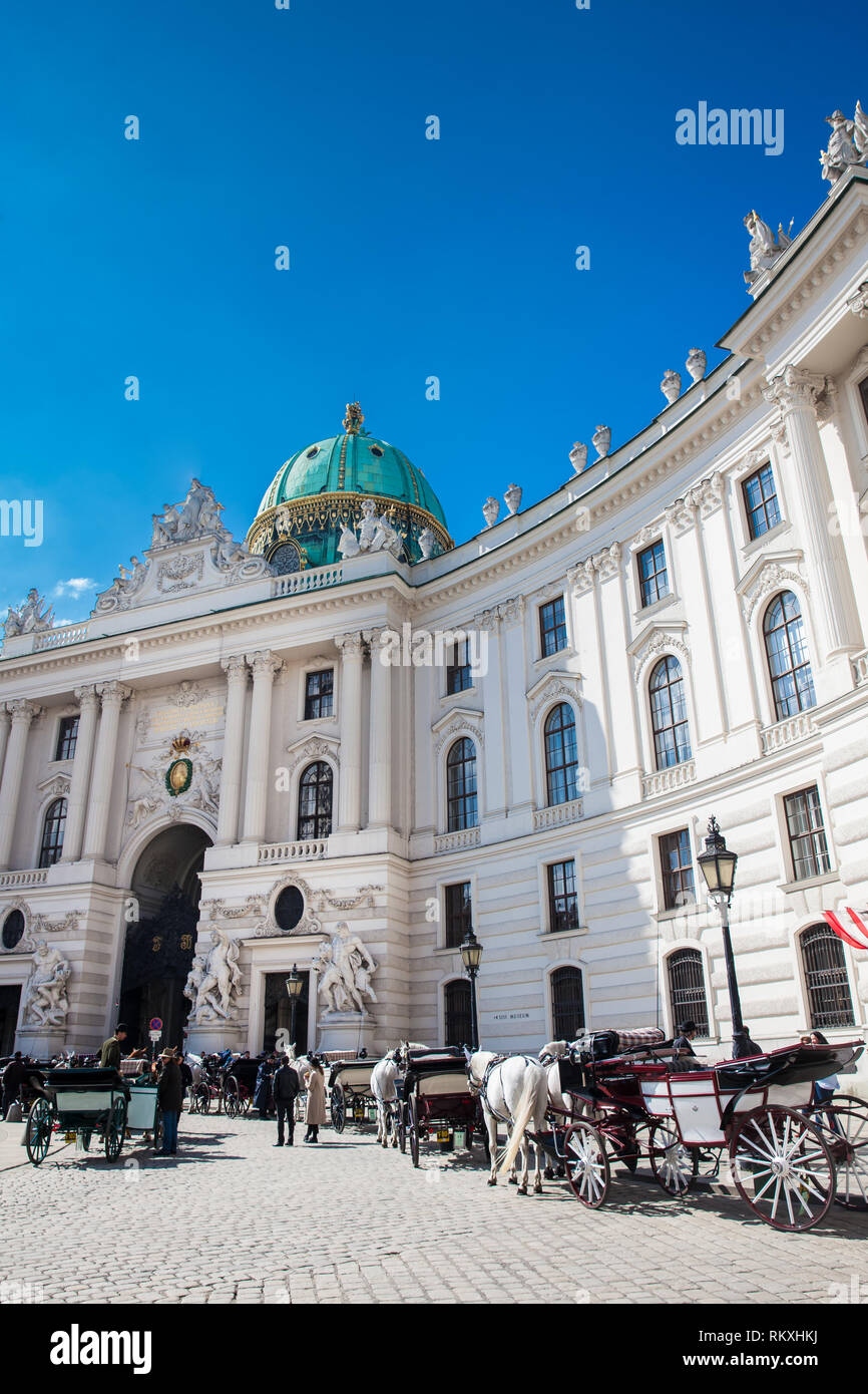 VIENNA, AUSTRIA - APRIL, 2018: Horse-drawn carriages in front of the Hofburg Imperial Palace in Vienna Stock Photo