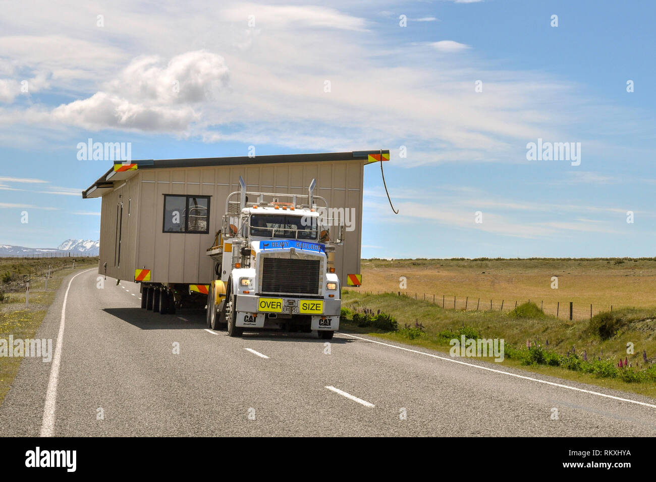 House being moved on a lorry, road from Lake Pukaki, South Island, New Zealand Stock Photo