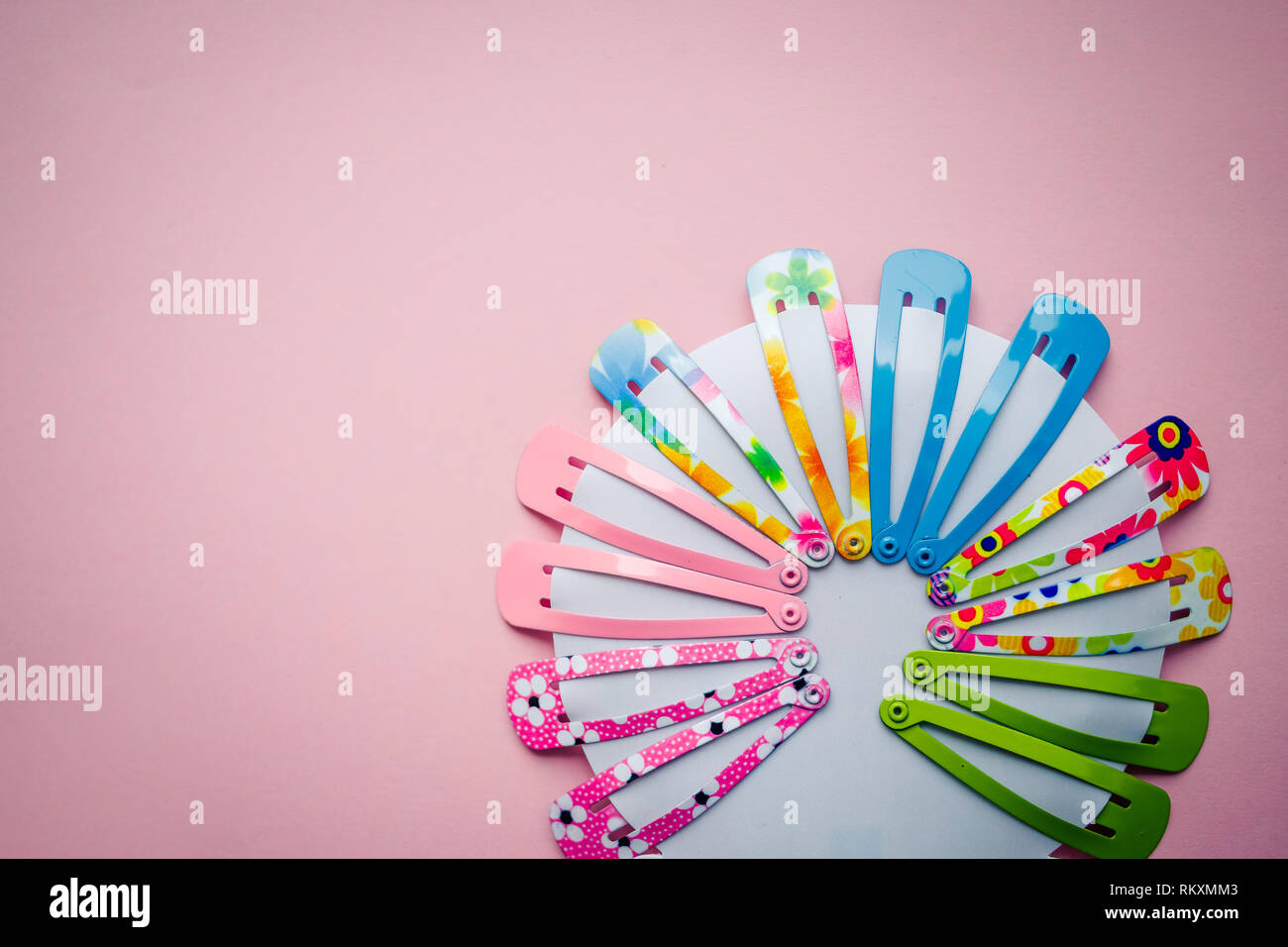 stylish fashion hair accessories for girls, baby. Spring colors. Glamor  girl, creative look with trendy hair style, hair clips on pink background  Stock Photo - Alamy