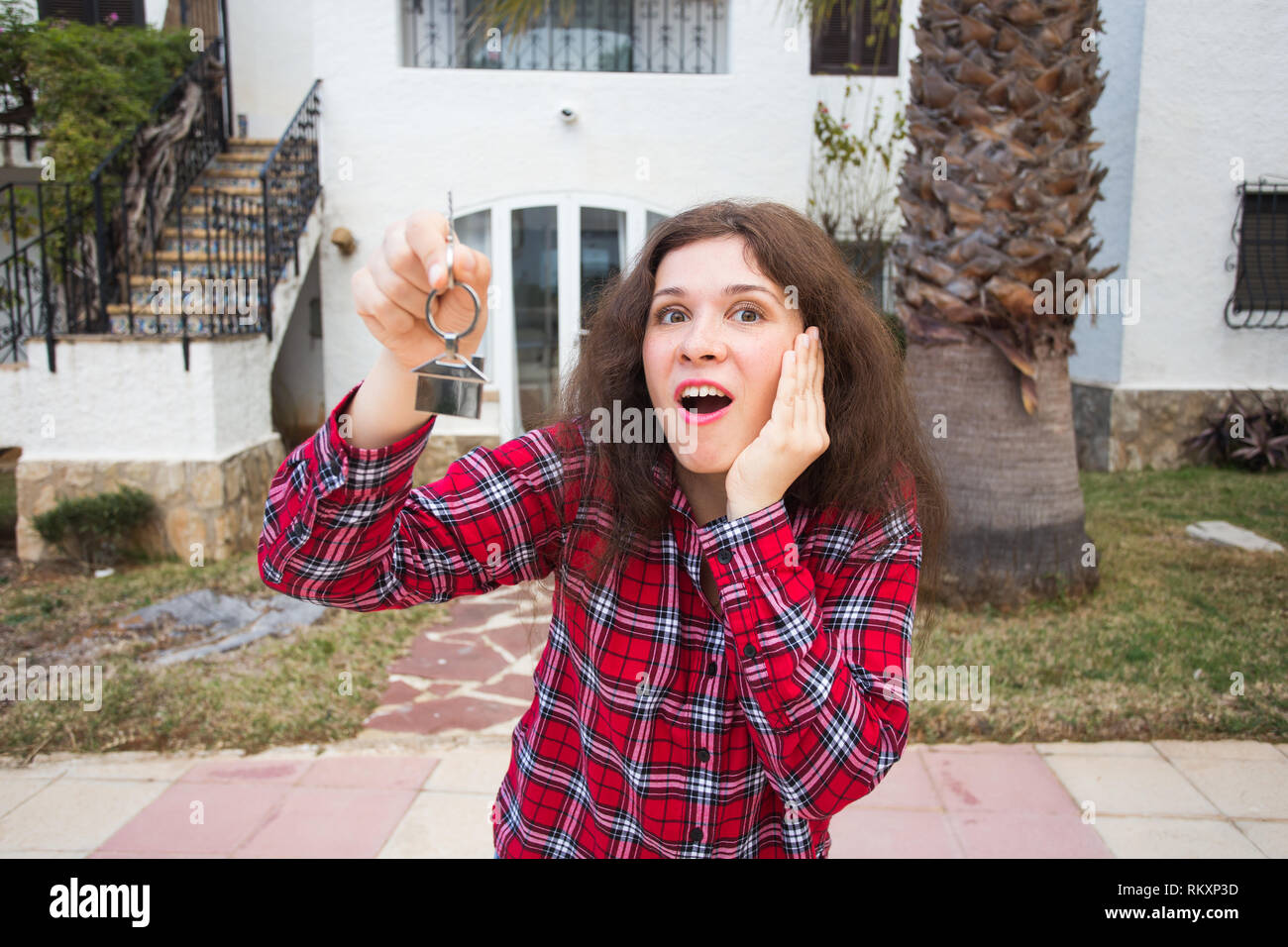 Real estate and property concept - Happy young woman in front of new ...