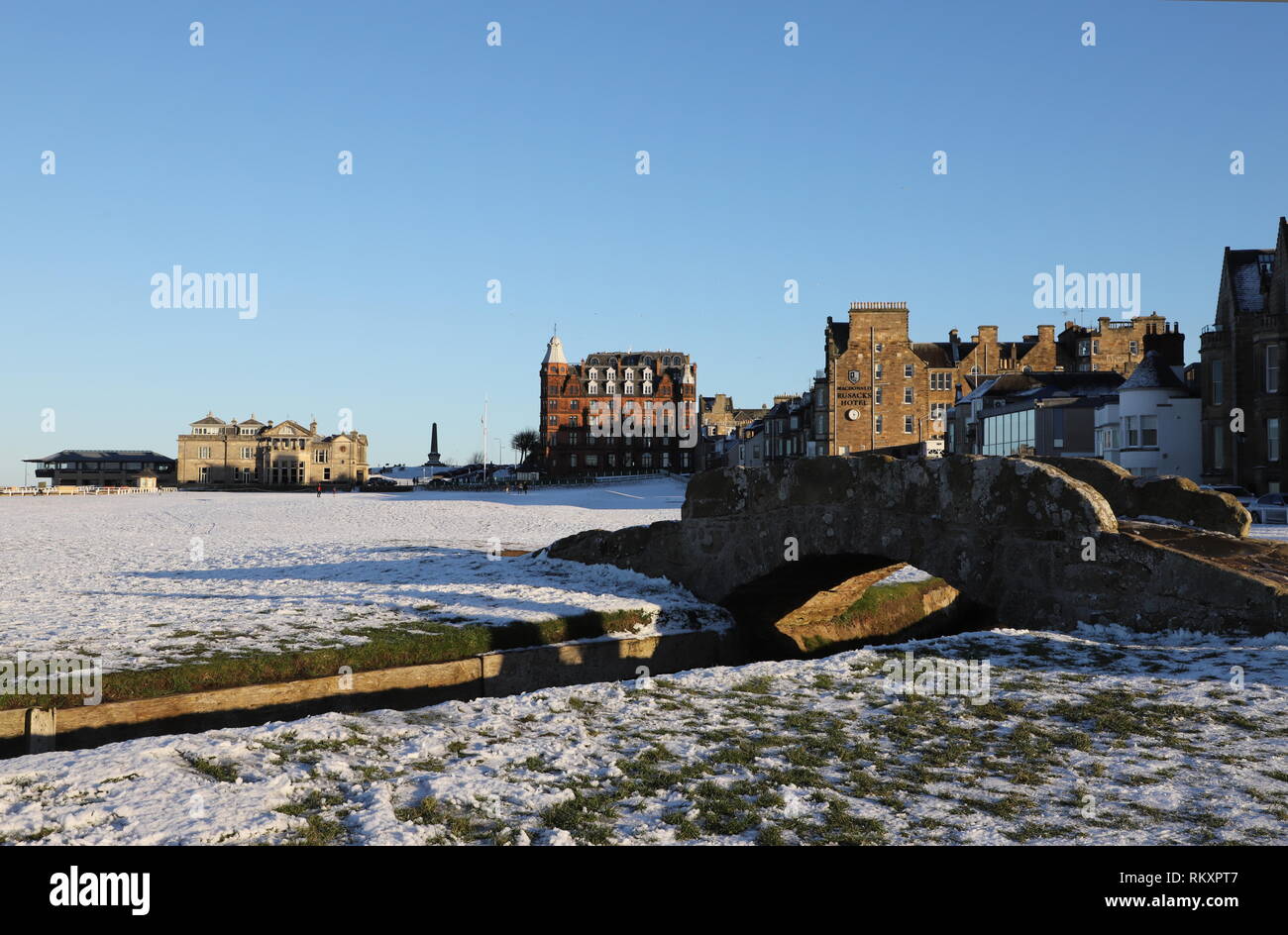 Swilken Bridge and Royal and Ancient Clubhouse with snow St Andrews Fife Scotland   February 2019 Stock Photo