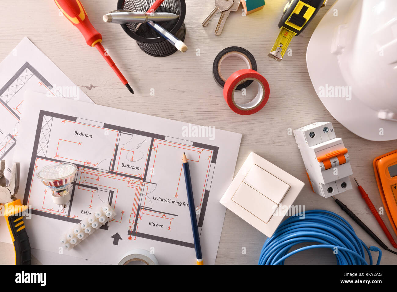Office table of electrical engineer with installation project and tools