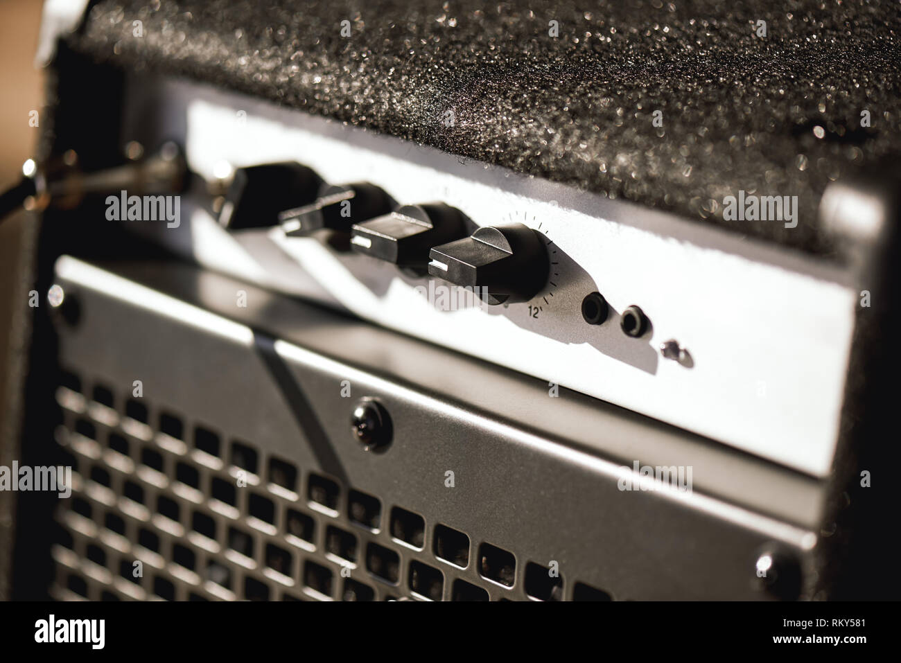 Closeup photo of guitar amplifier with cable audio jack. Musical