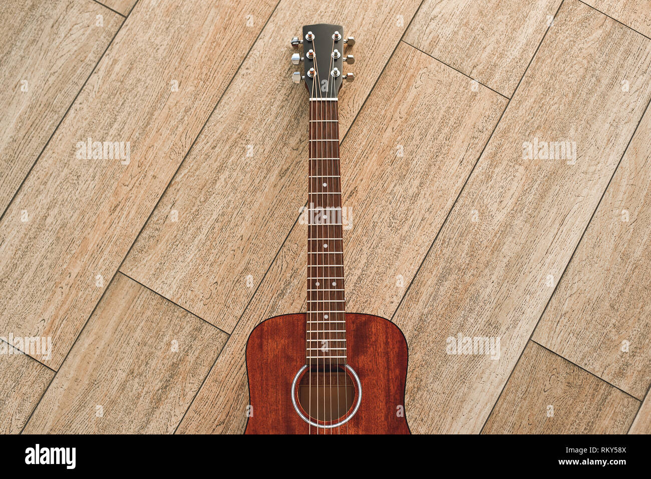 The most elegant instrument. Top view of the brown acoustic guitar
