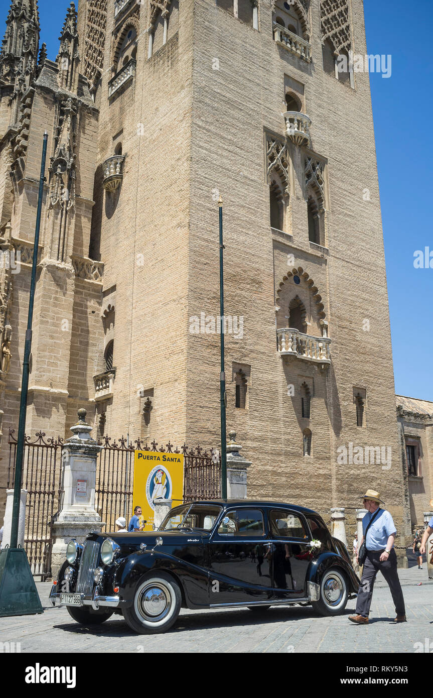 Vintage wedding car outside the Gothic Cathedral in Seville, Spain. Stock Photo