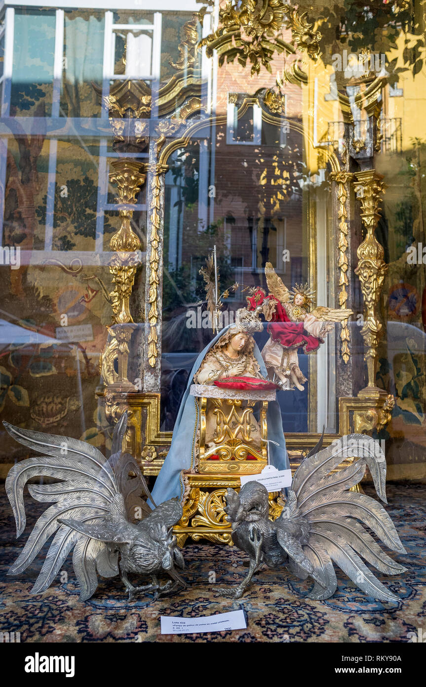 Reflections in a religious curios shop window in Seville, Spain Stock Photo