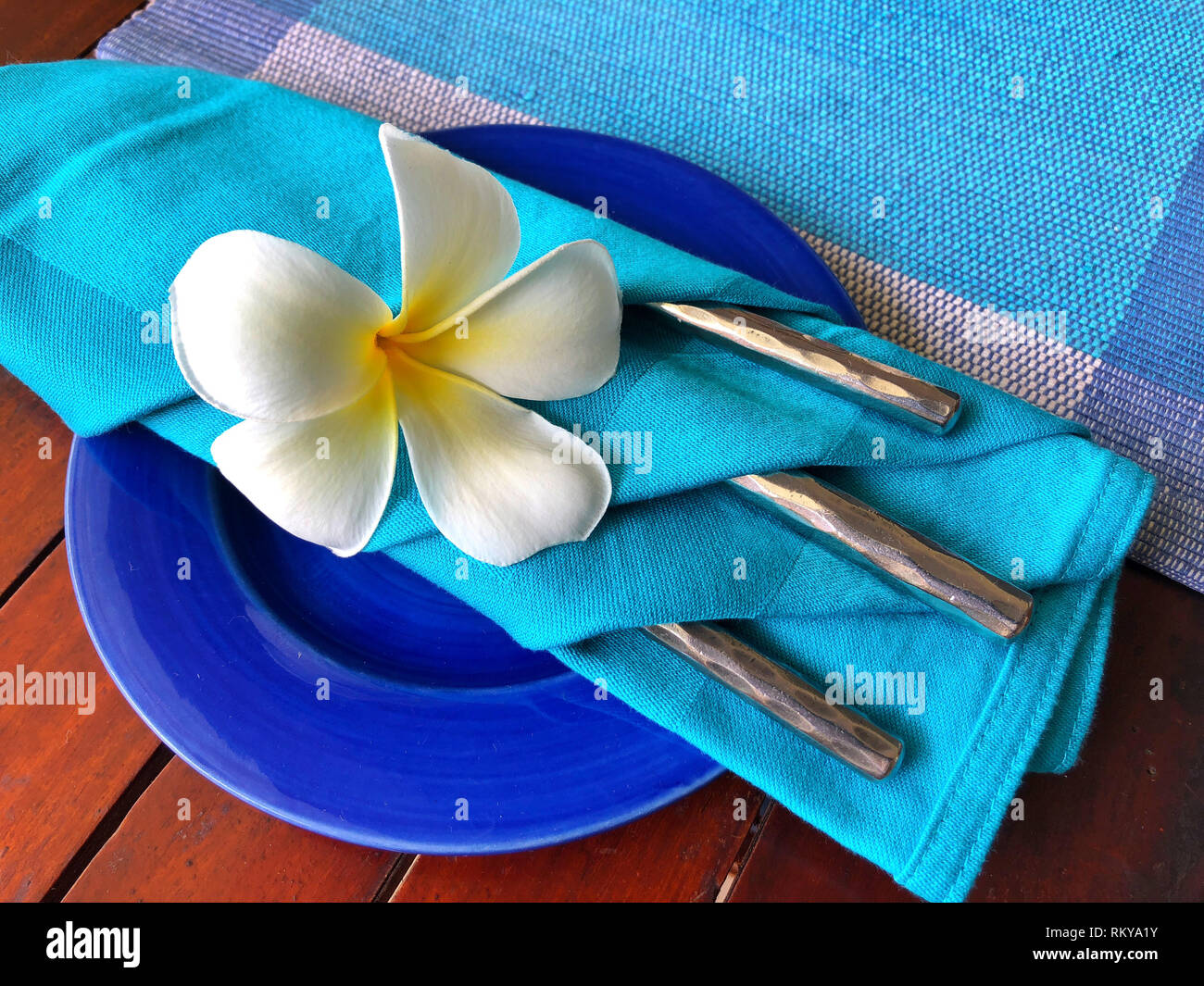 Food decoration with white plumeria rubra flower, Sri Lanka. Blue food