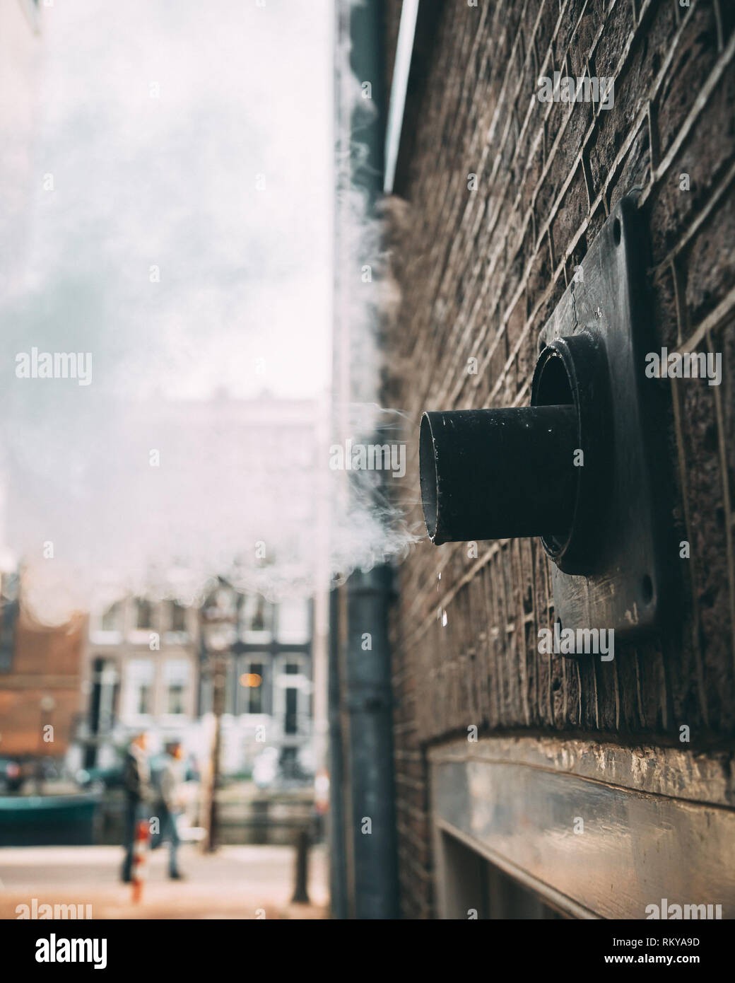 Steam exhaust pipe on the side of a brick building Stock Photo Alamy