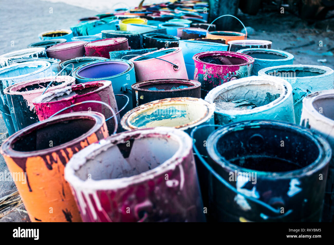 Empty paint buckets of various colours at Salvation Mountain. Stock Photo