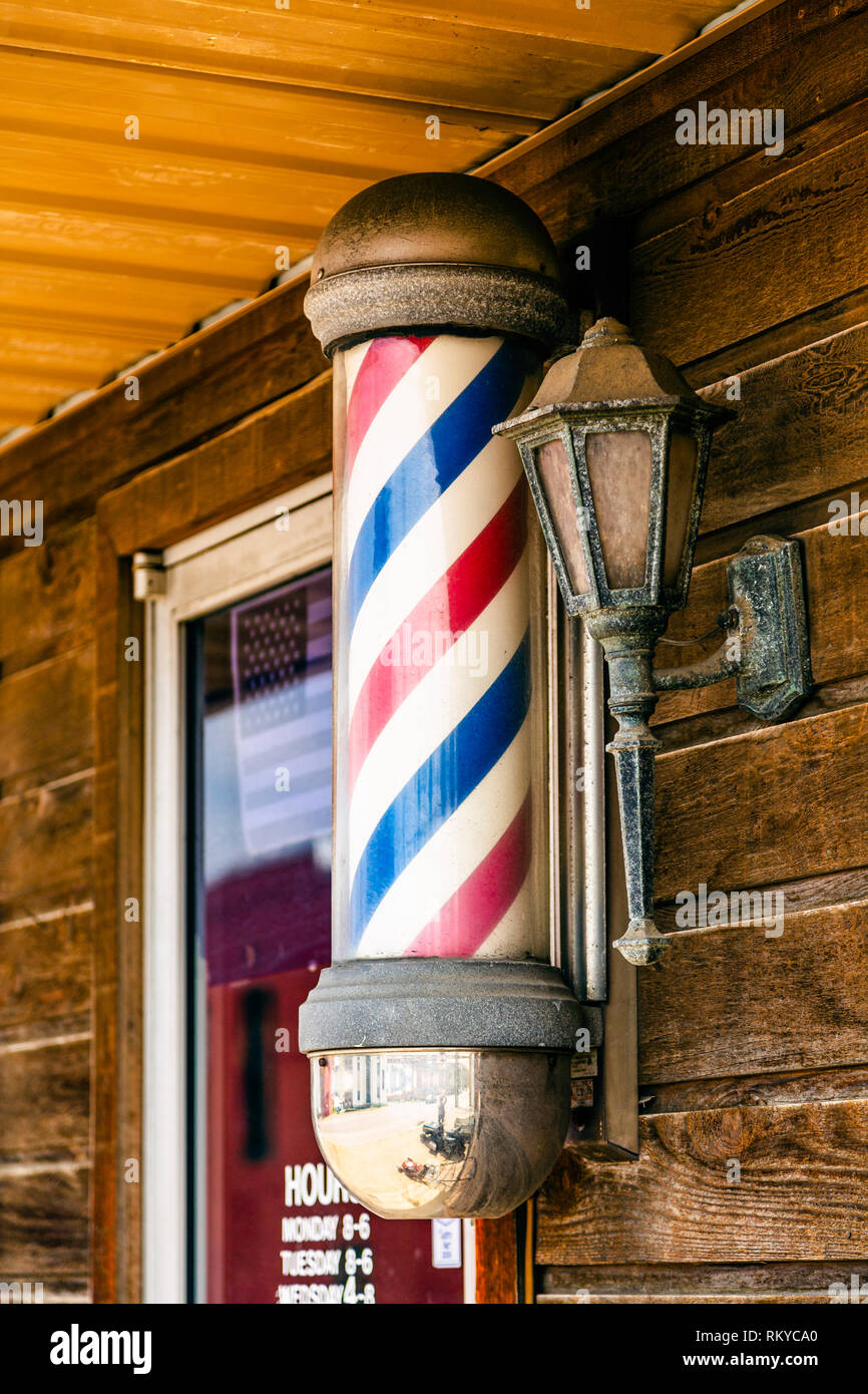 Classic barber pole sign outside barber shop in Lawrenceburg in Kentucky  Stock Photo - Alamy