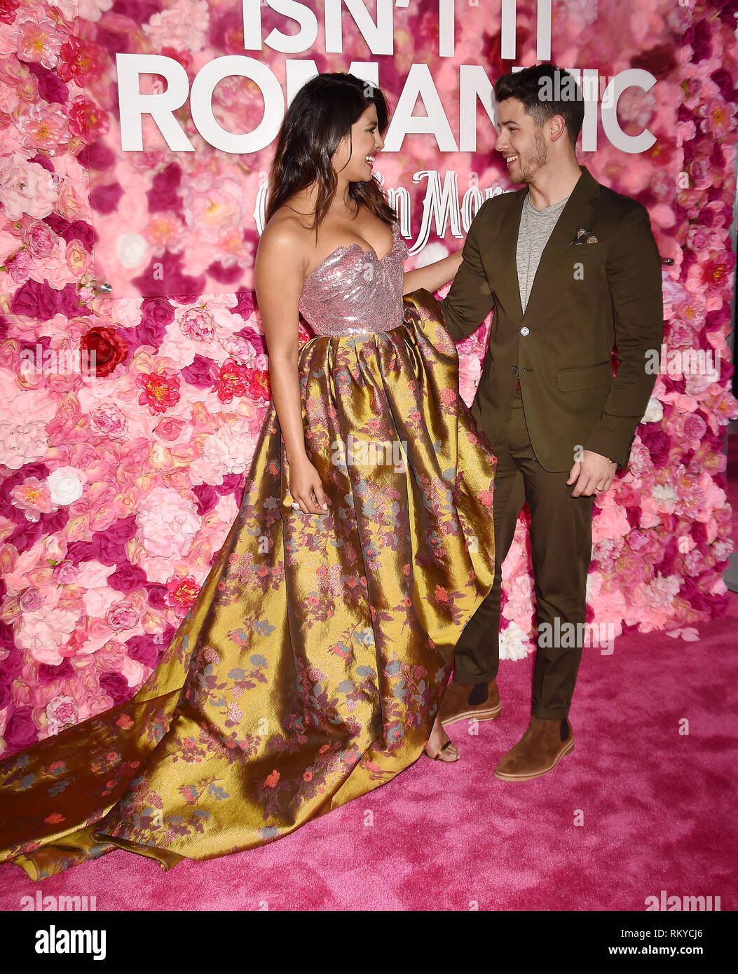 LOS ANGELES, CA - FEBRUARY 11: Priyanka Chopra (L) and Nick Jonas arrive at the Premiere Of Warner Bros. Pictures' 'Isn't It Romantic' at The Theatre  Stock Photo