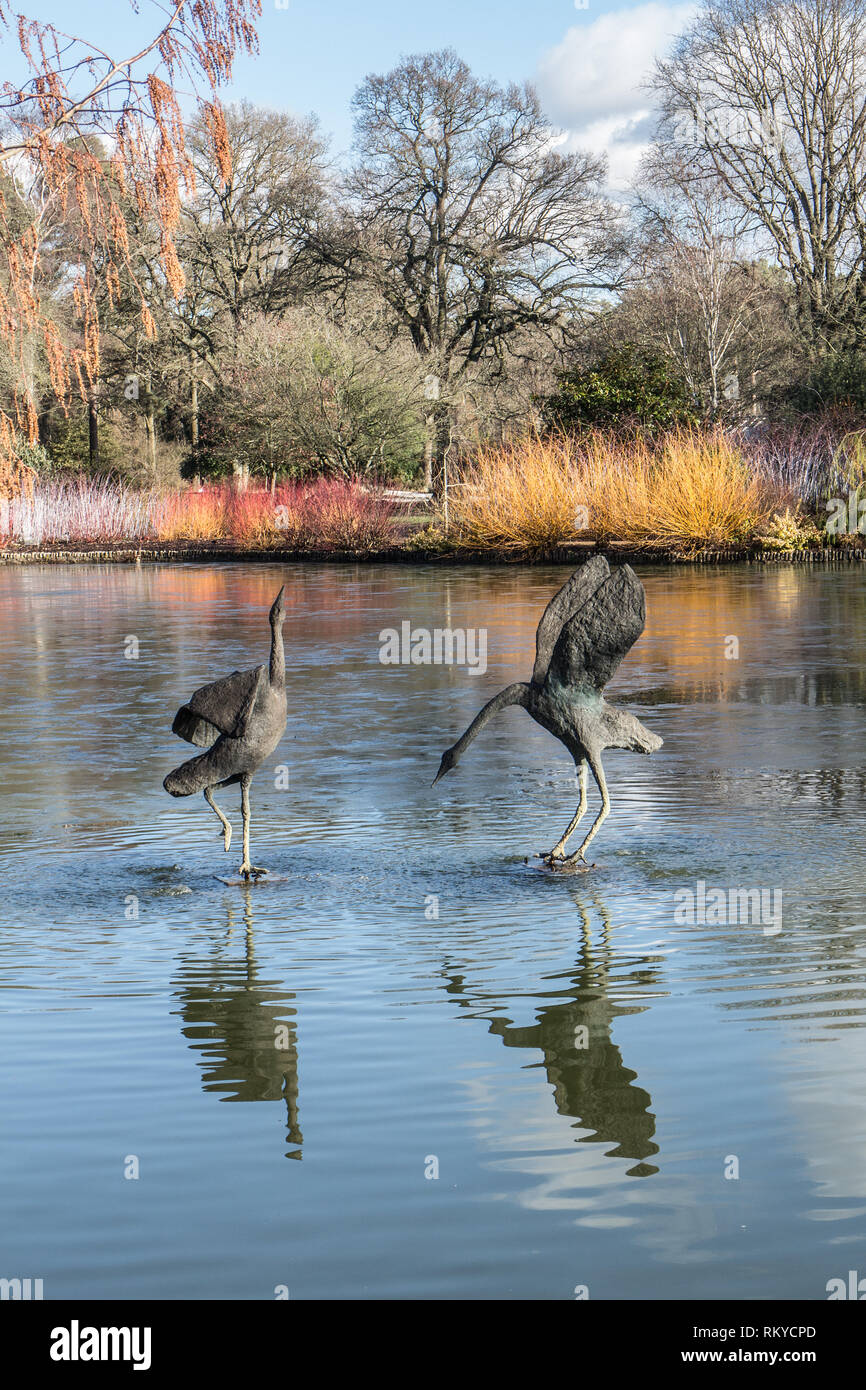 Crane sculptures on lake in Winter  at RHS Wisley Garden, Surrey Stock Photo