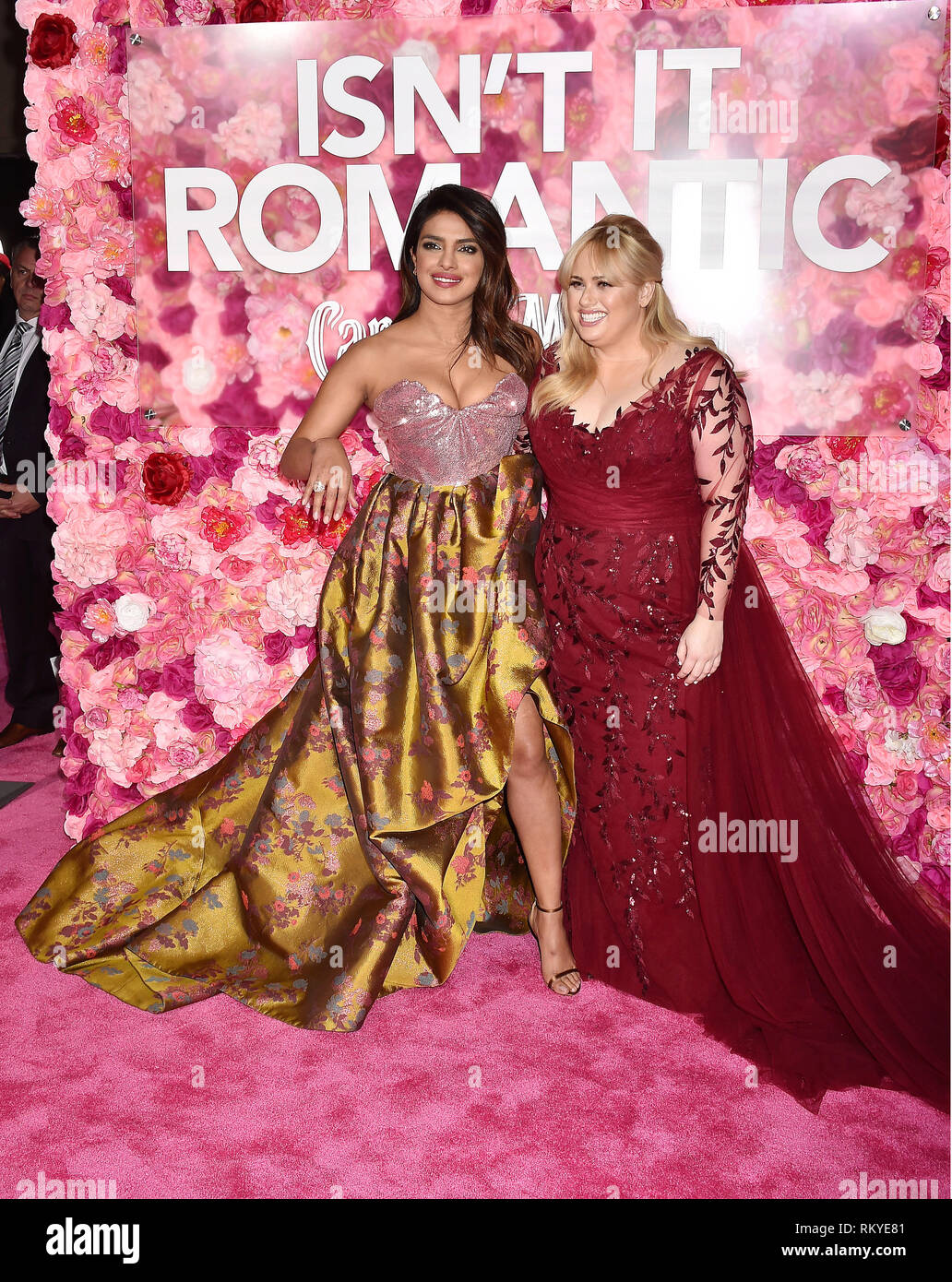 LOS ANGELES, CA - FEBRUARY 11: Priyanka Chopra (L) and Rebel Wilson arrive at the Premiere Of Warner Bros. Pictures' 'Isn't It Romantic' at The Theatr Stock Photo