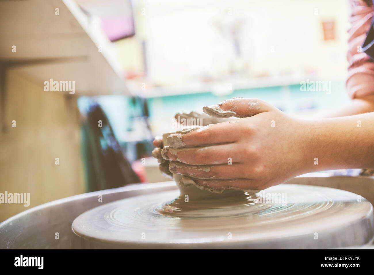Child hands shaping clay on pottery wheel at workshop Stock Photo - Alamy