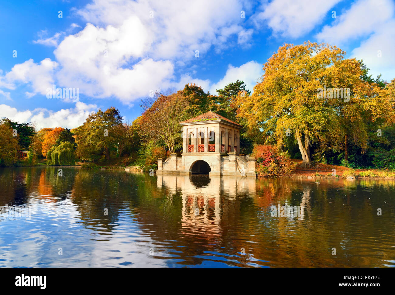 An autumn view of the Roman Boathouse and lake in Birkenhead Park in ...
