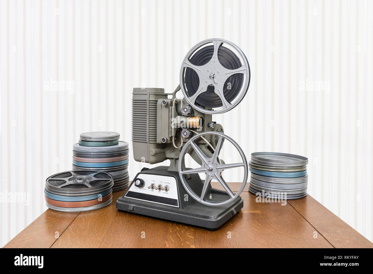 Vintage 8mm home movie projector and film cans on wood table Stock Photo -  Alamy