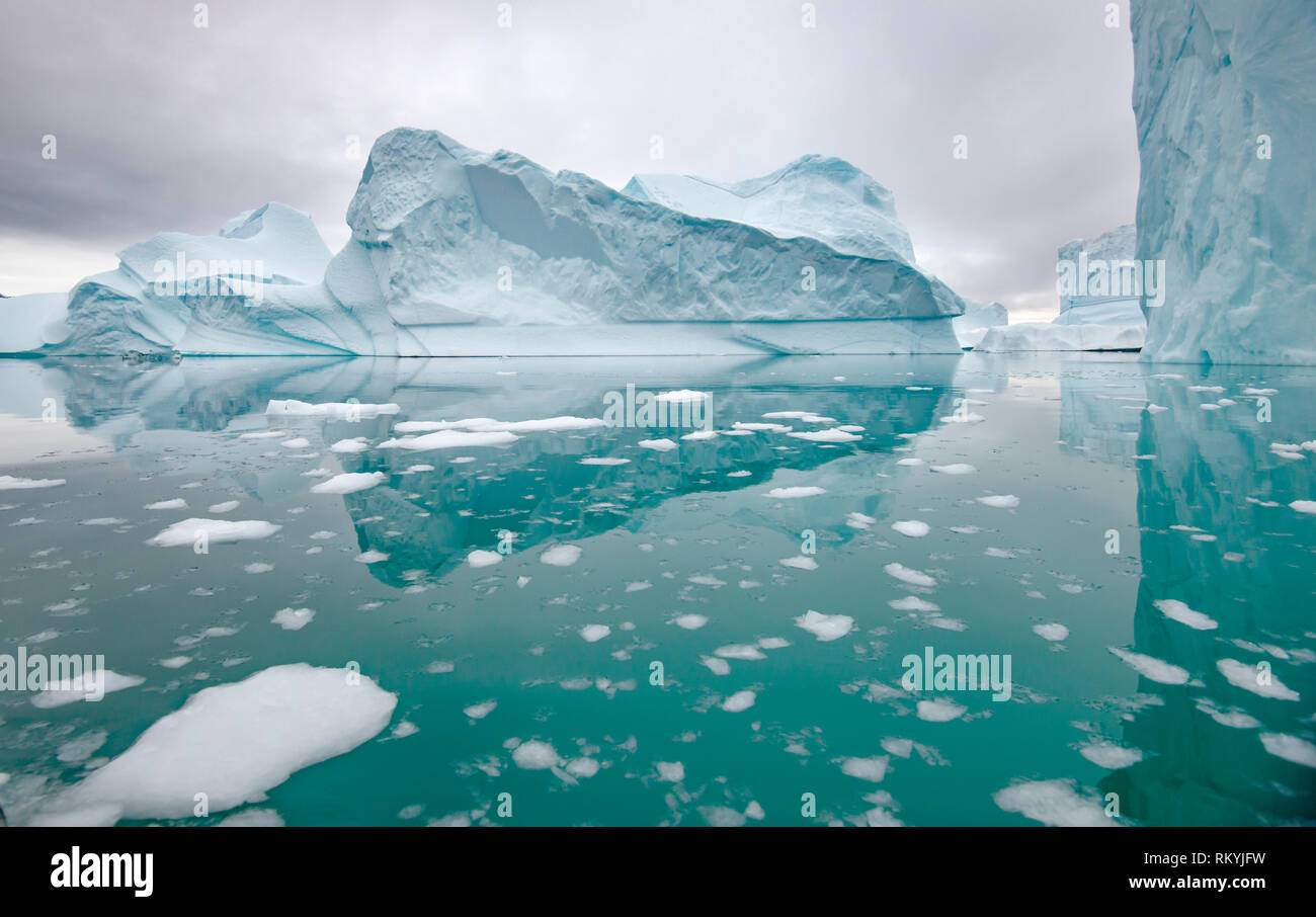 Icebergs reflected in the calm waters of Rode Fjord. Stock Photo