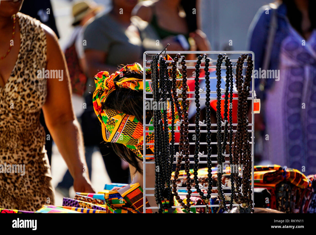 African jewelery and fibric on sales table in outdoor market during Toronto Harbourfront Babados Festival Stock Photo