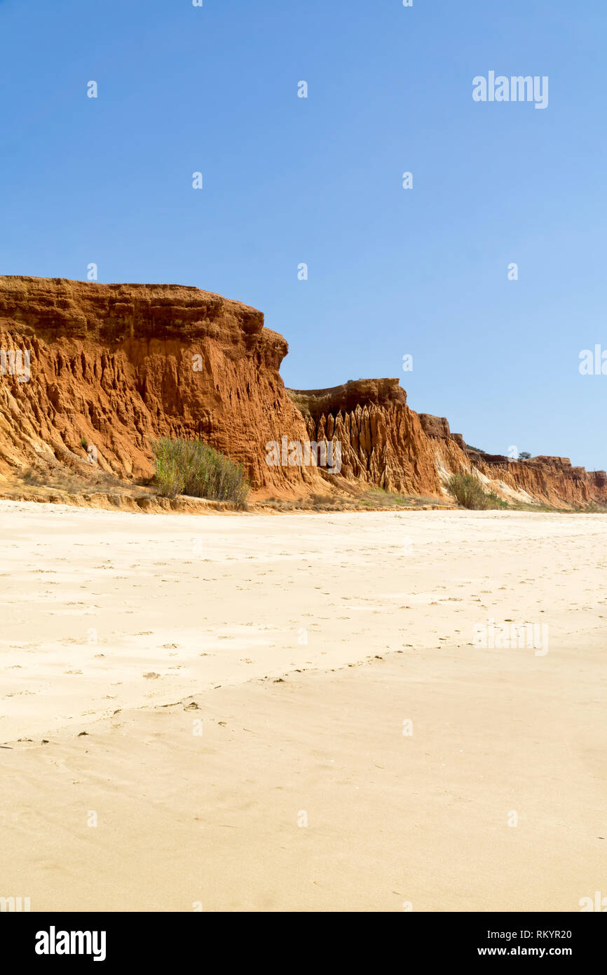 High cliffs along Falesia Beach and The Atlantic Ocean in Albufeira, Algarve, Portugal. Sunny summer day, blue sky. Stock Photo
