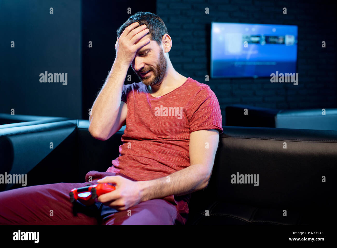 Man Losing In Video Game Sitting On The Couch With Sad