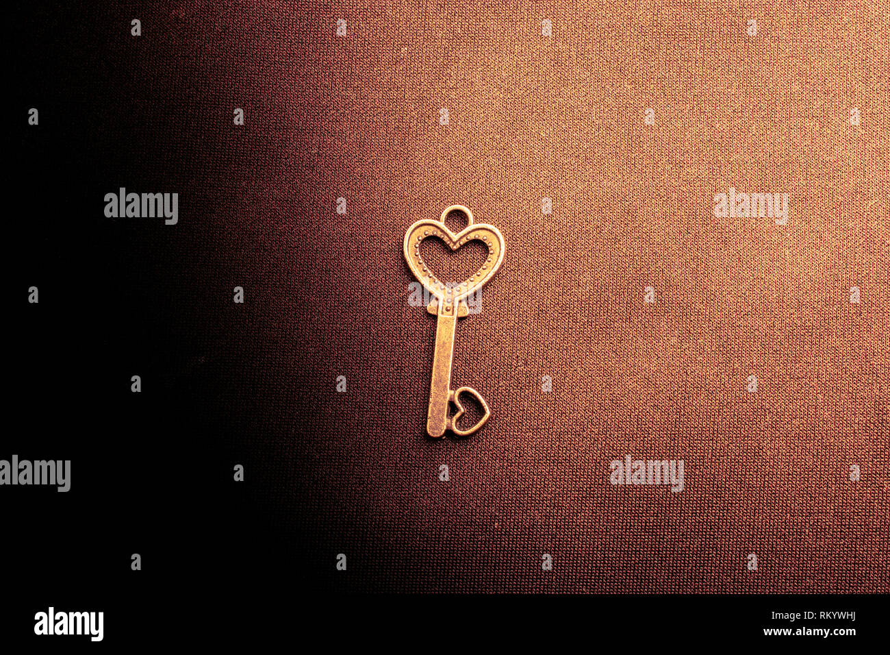 Heart shaped retro metal key on plain background Stock Photo - Alamy