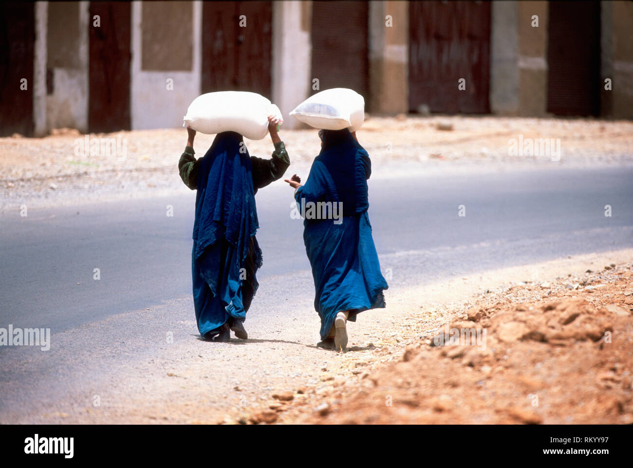 women carrying rice on their heads Stock Photo - Alamy