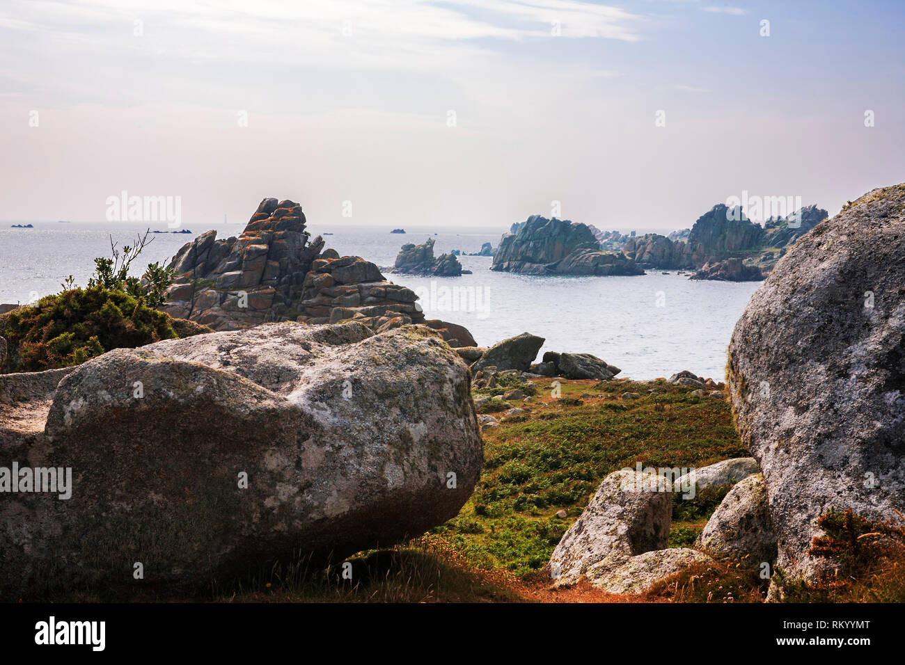 Porth Warna: looking across the rocky bay towards Bishop Rock lighthouse from St. Warna's Carn, St. Agnes, Isles of Scilly, England, UK Stock Photo