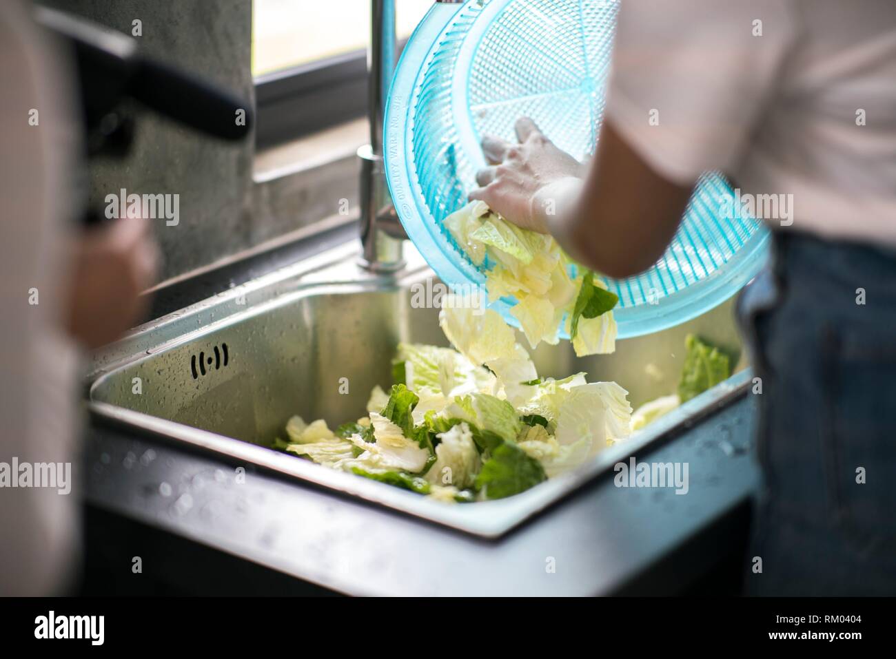 Cleaning vegetables with water, Kuching, Sarawak, Malaysia Stock Photo