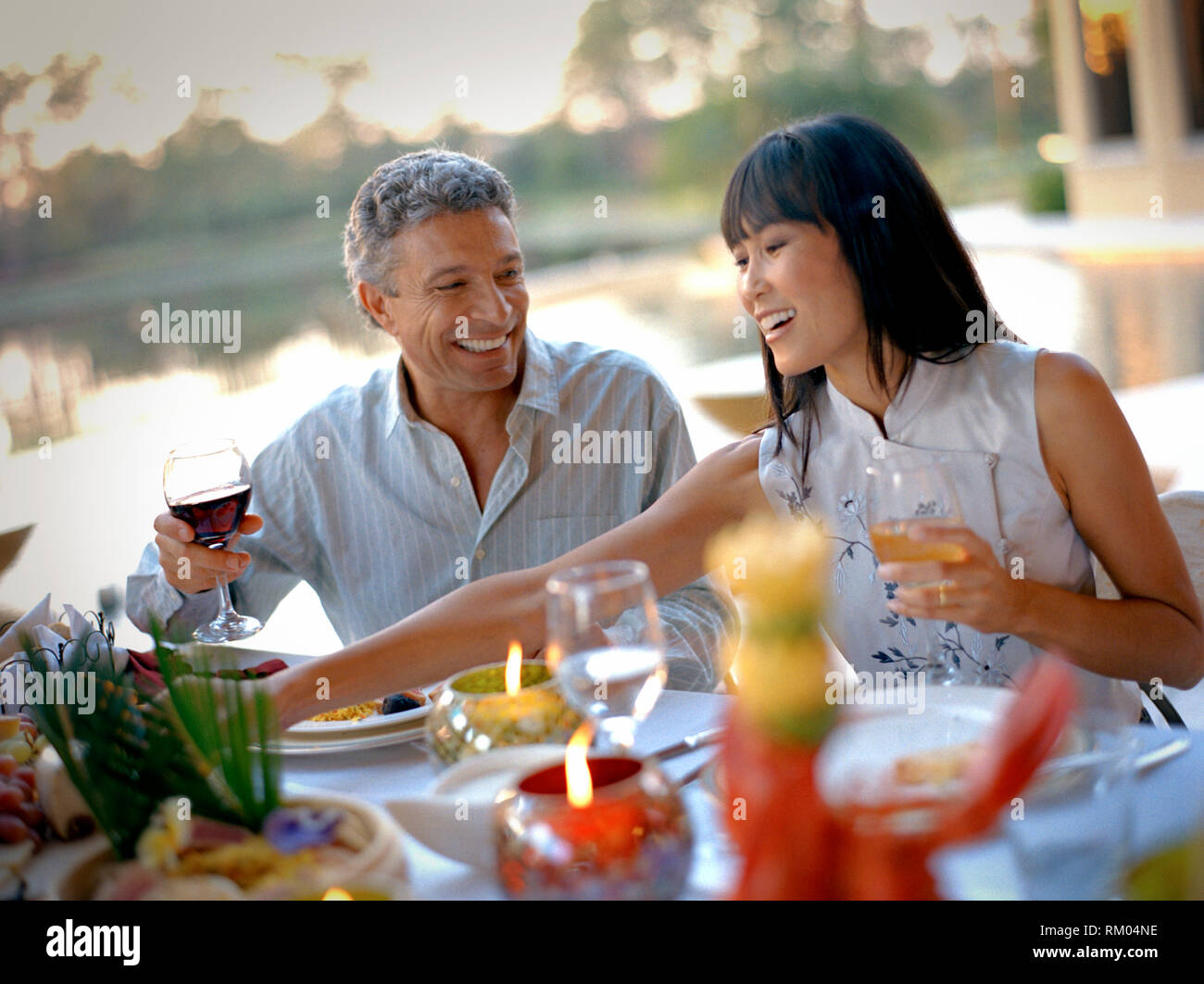 Man and woman laughing during a dinner party Stock Photo - Alamy