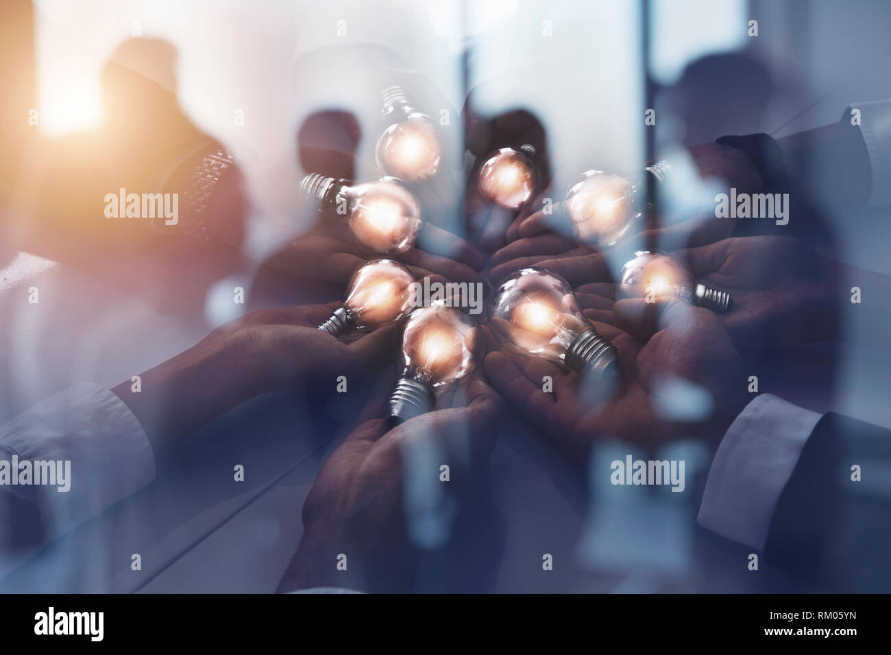 Teamwork and brainstorming concept with businessmen that share an idea with a lamp. Concept of startup. Double exposure Stock Photo