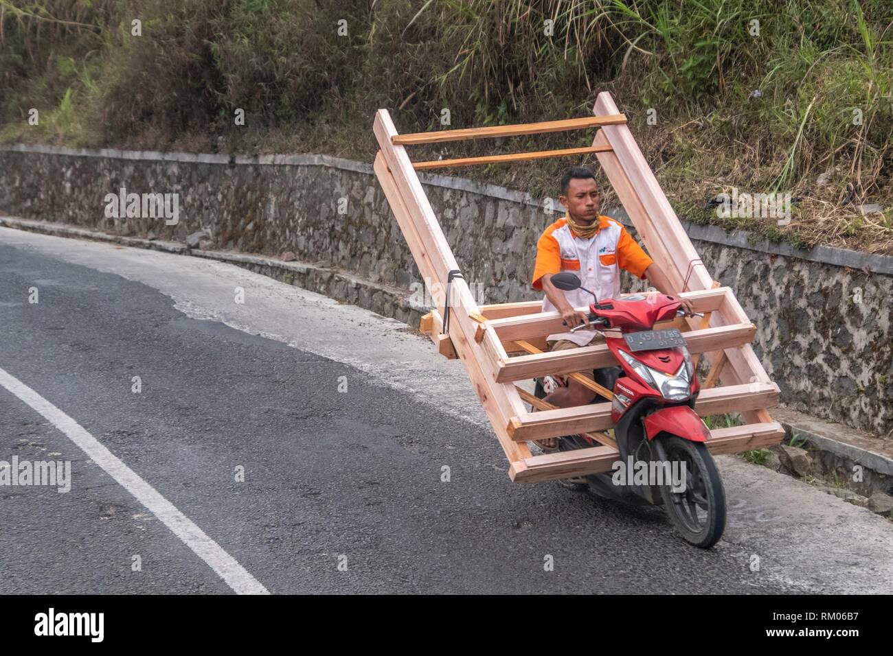 Carrying door frames on motorbike, Ciwidey, Badung, Java, Indonesia Stock Photo