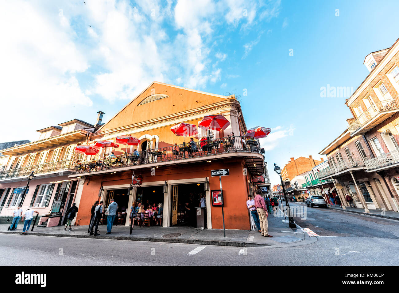 New Orleans, USA - April 23, 2018: Old town Chartres street in Louisiana famous city shops in sunset evening day with cast iron balconies restaurant w Stock Photo