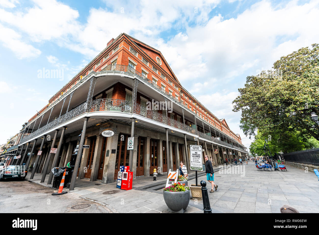 New Orleans, USA - April 23, 2018: Old town Chartres and St Ann street in Louisiana famous city shops in sunset evening day with cast iron balconies r Stock Photo