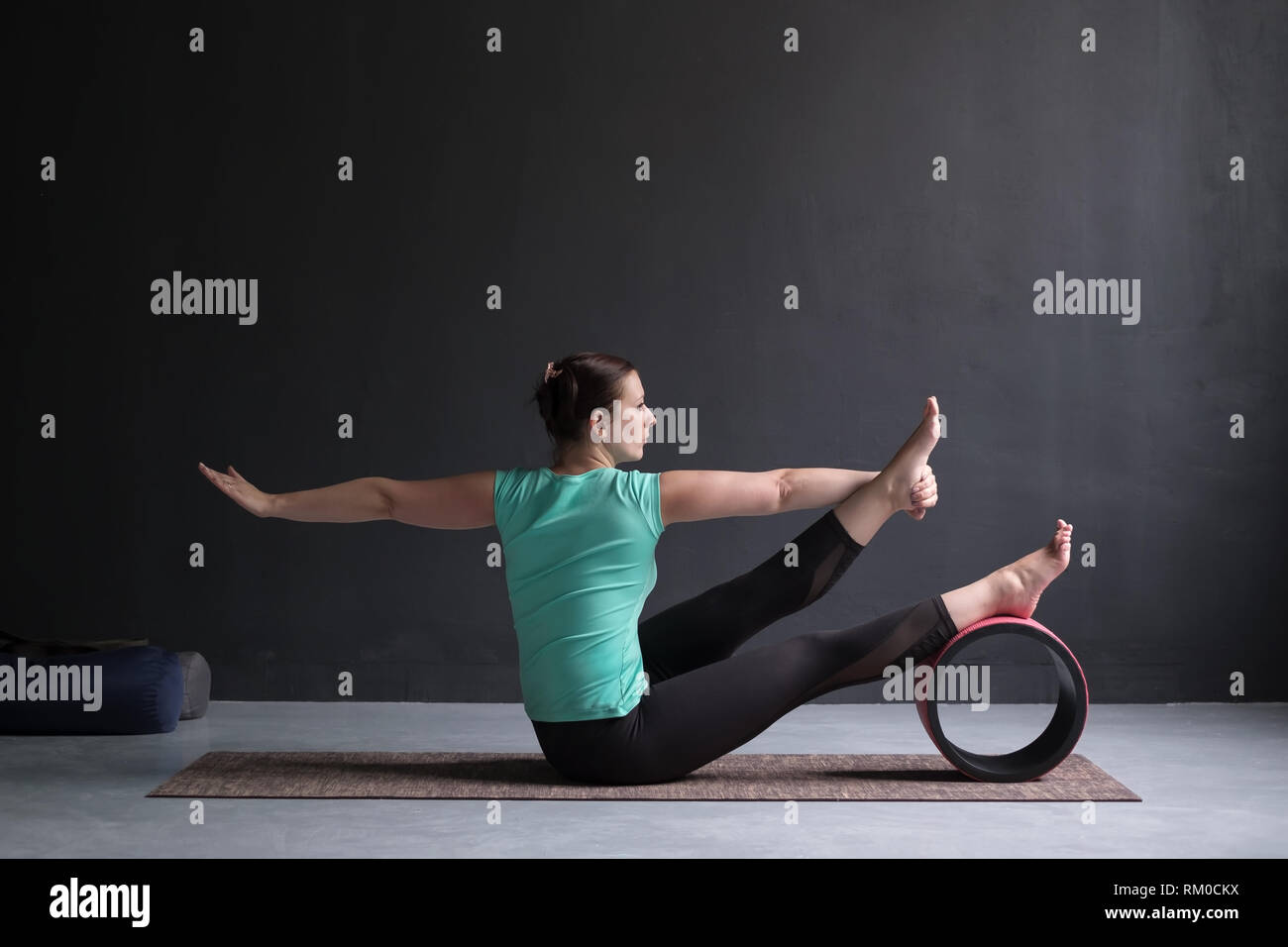 Yoga girl doing parivrtta navasana or twisted boat pose Stock Photo - Alamy