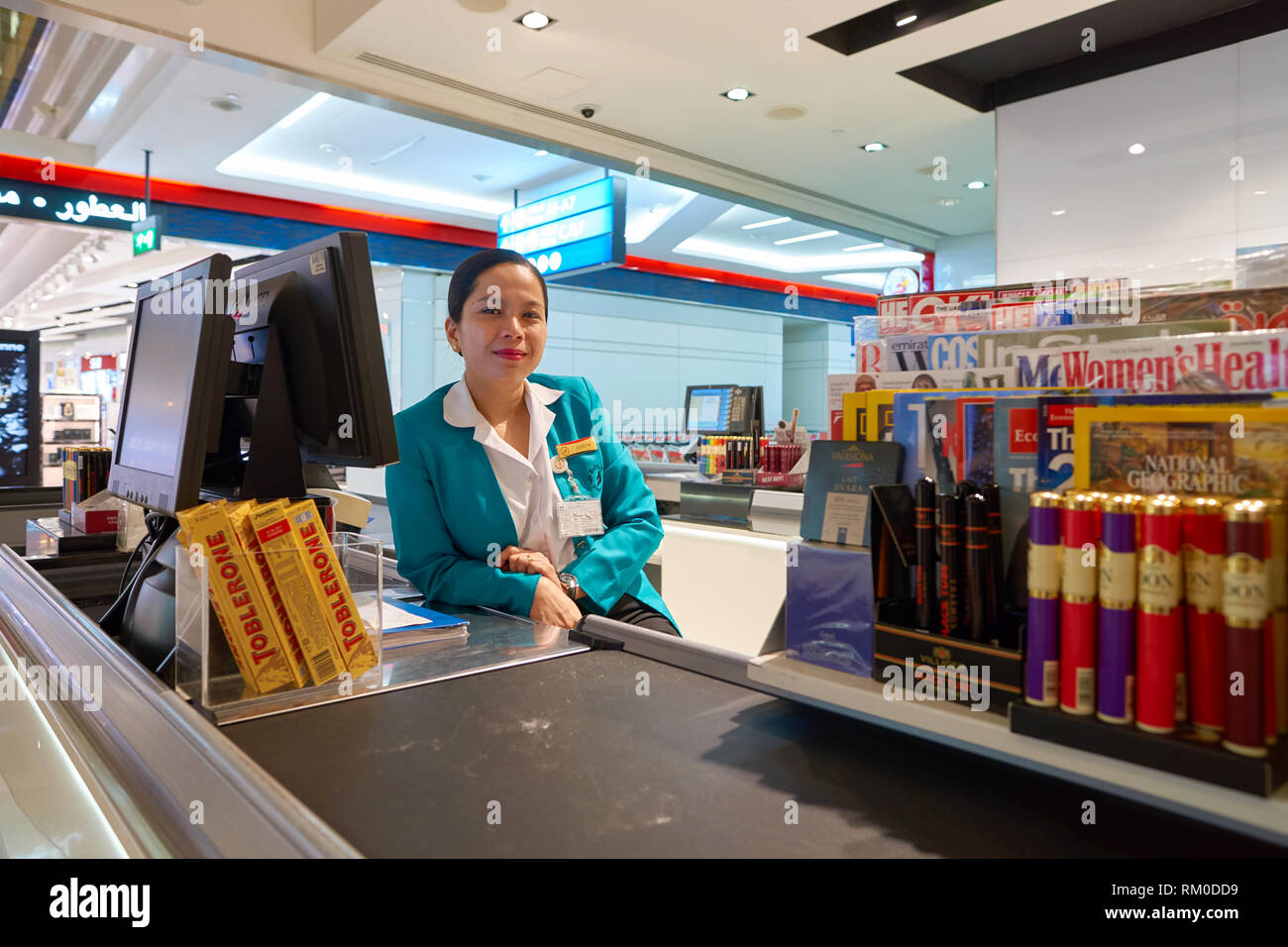 DUBAI, UAE - CIRCA NOVEMBER, 2016: indoor portrait of cashier at Dubai International Airport. Stock Photo