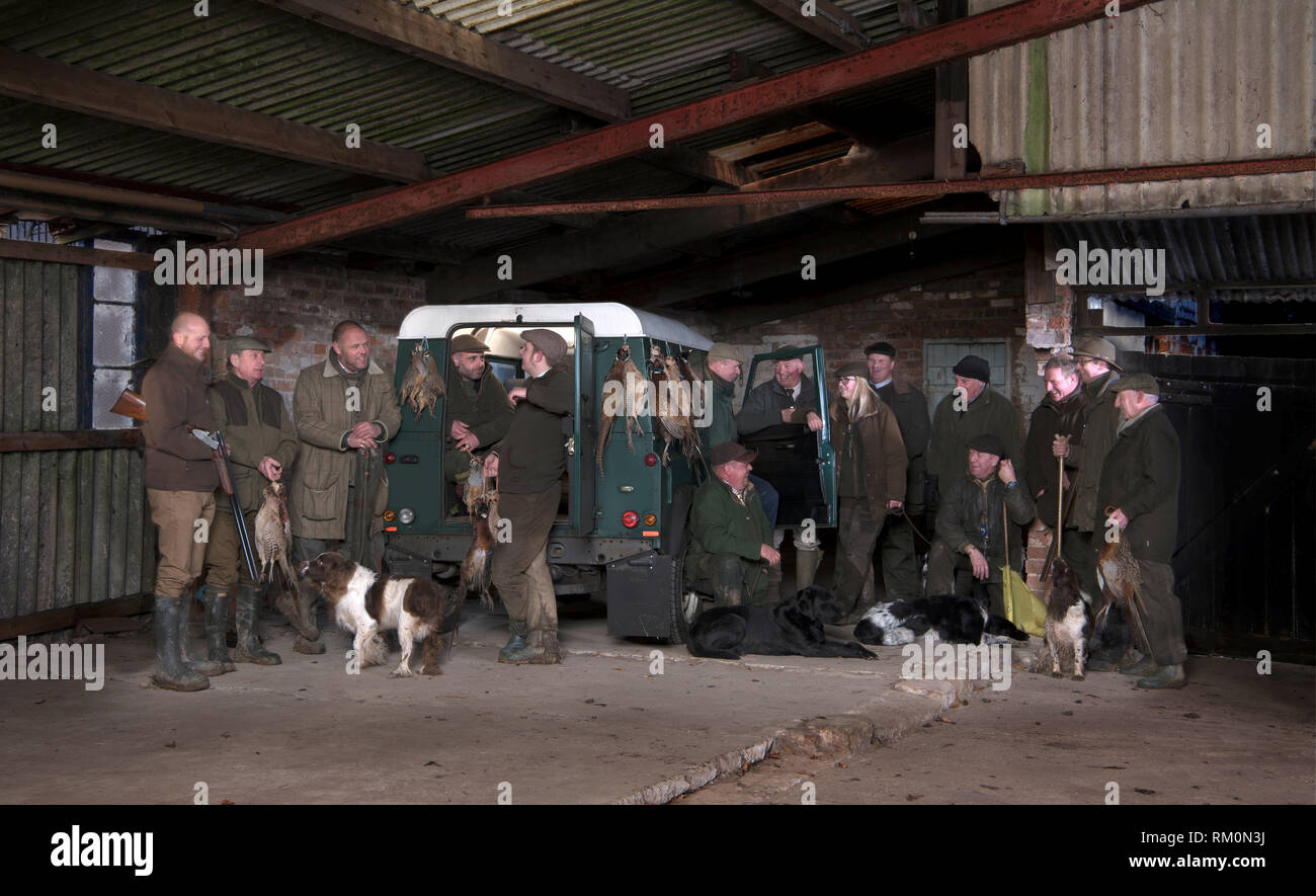 Game shooters with gun dogs and pheasants and partridges. Stock Photo
