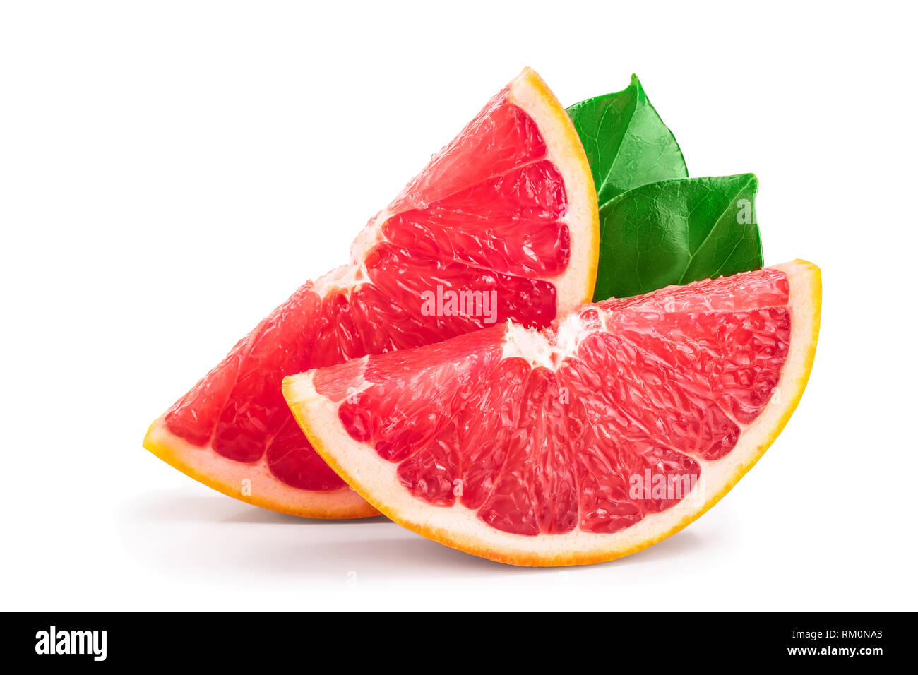 Grapefruit slices with leaves isolated on white background. Stock Photo