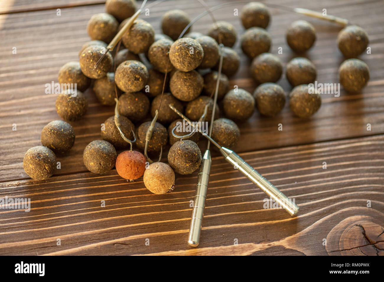 Carp fishing. Different of carp boilies and accessories for carp fishing  isolated on wooden background Stock Photo - Alamy