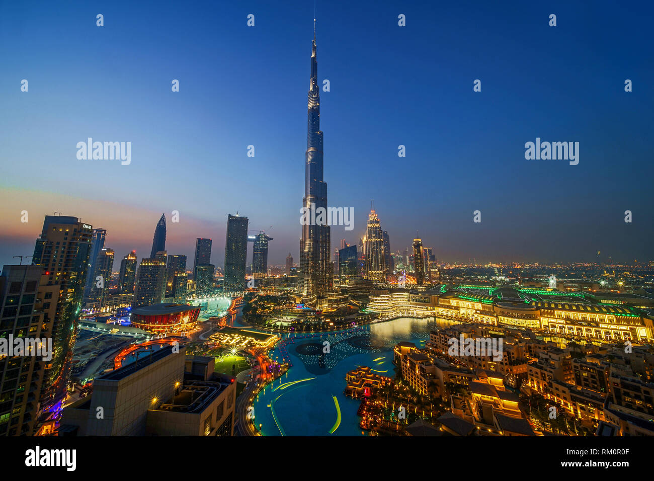 The Burj Khalifa soars 829 meters into the clear Arabian sky and towers over the luxuriant oasis of Dubai. Stock Photo
