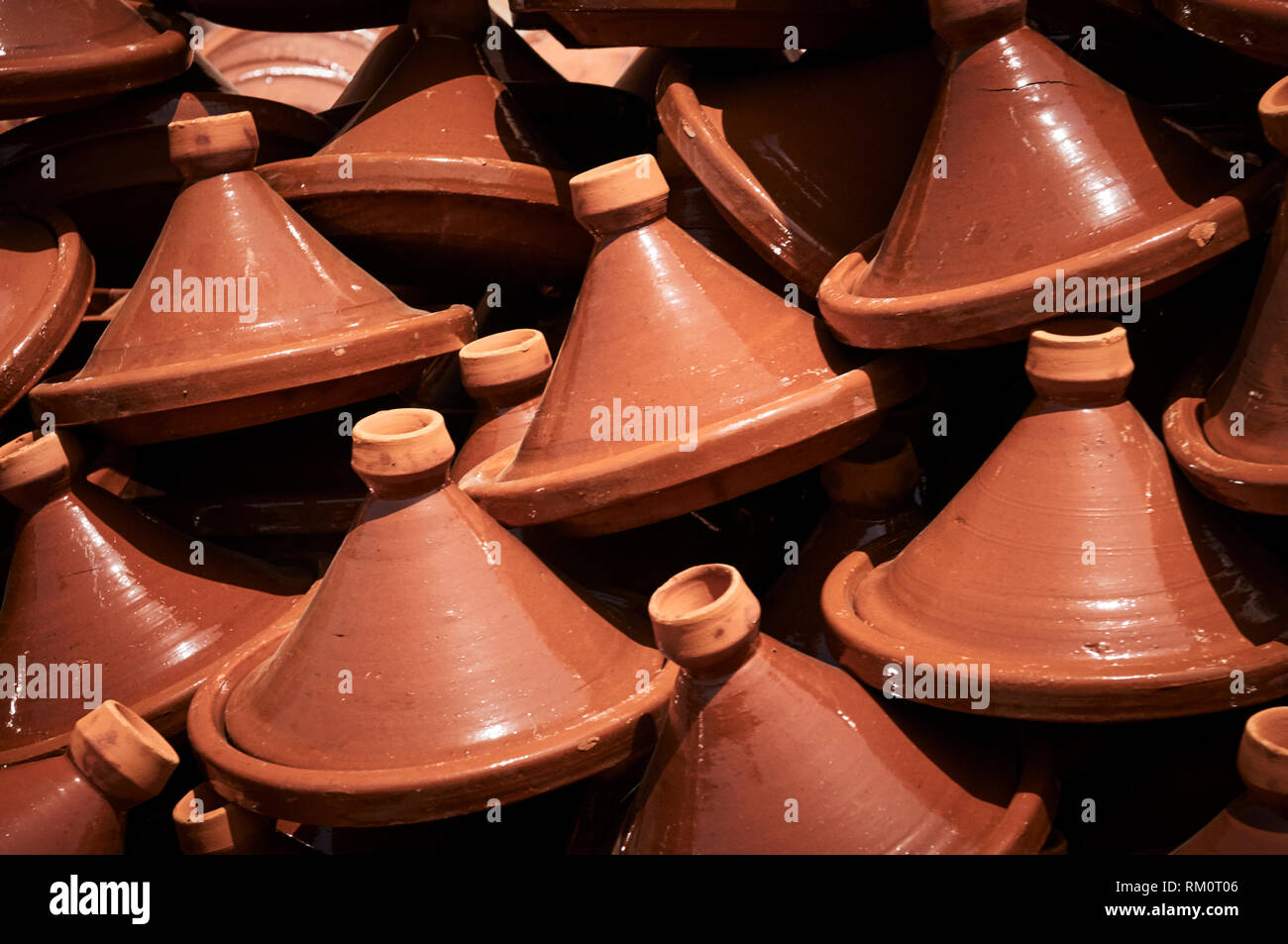 Hand crafted terracotta pottery tagines created for cooking for sale at the Fez souq. Stock Photo