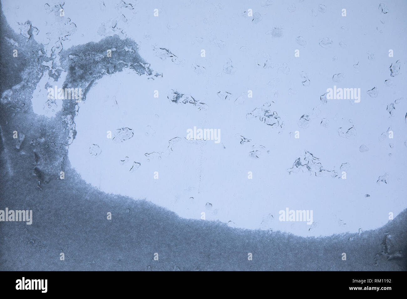 Melting snow and cold water, condensation on window glass, transparent