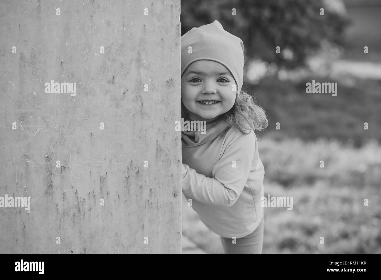 Girl in pink hat, clothes smile at grey wall Stock Photo Alamy
