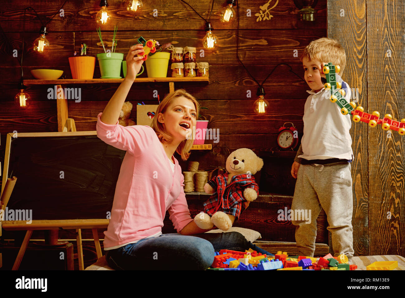 Daycare concept. Little child play daycare game with woman. Daycare preschool. Family daycare ...